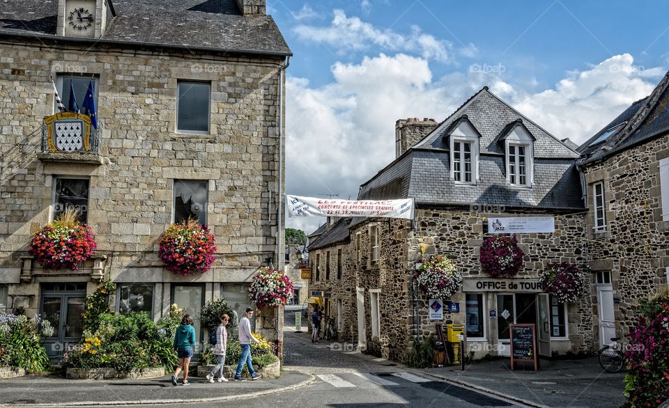 Tourists walk through the French village of Jugon les Lacs