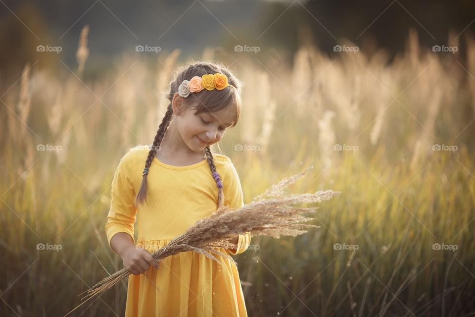 Little girl in yellow dress outdoor portrait 