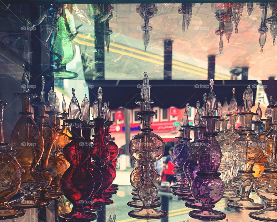 Colorful Perfume bottles reflects on the glass 