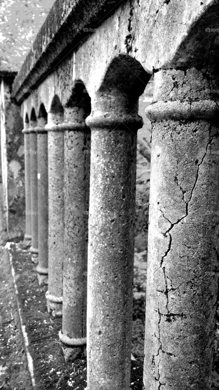 old cracked concrete or stone pillars on bridge railing