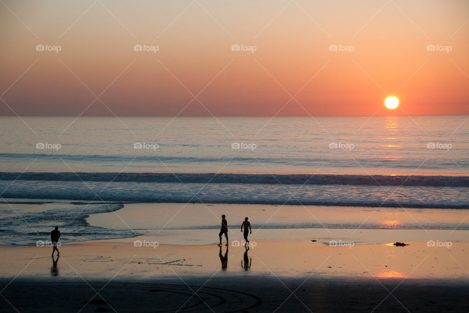 Playing on the beach at sunset in San Diego California