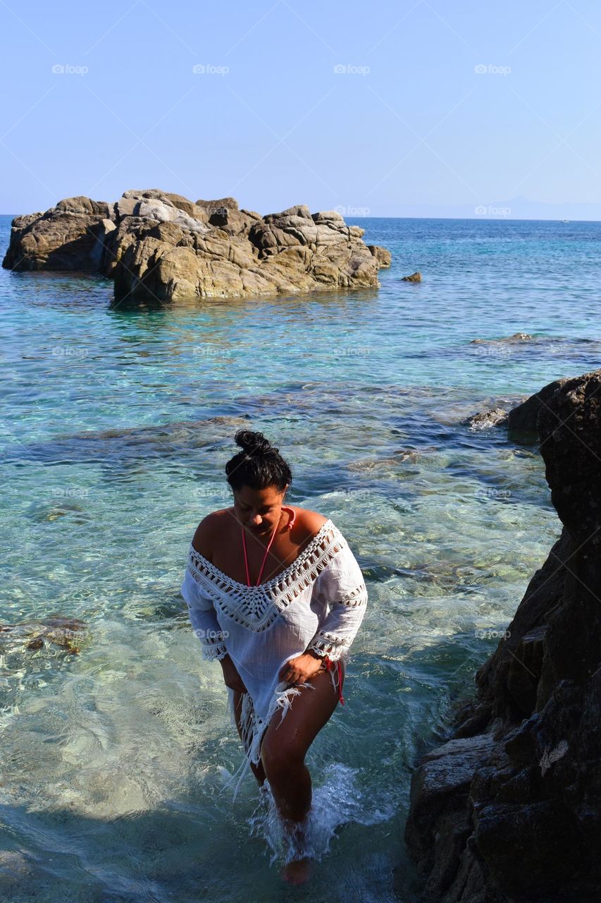 girl get's out of sea water at sunrise