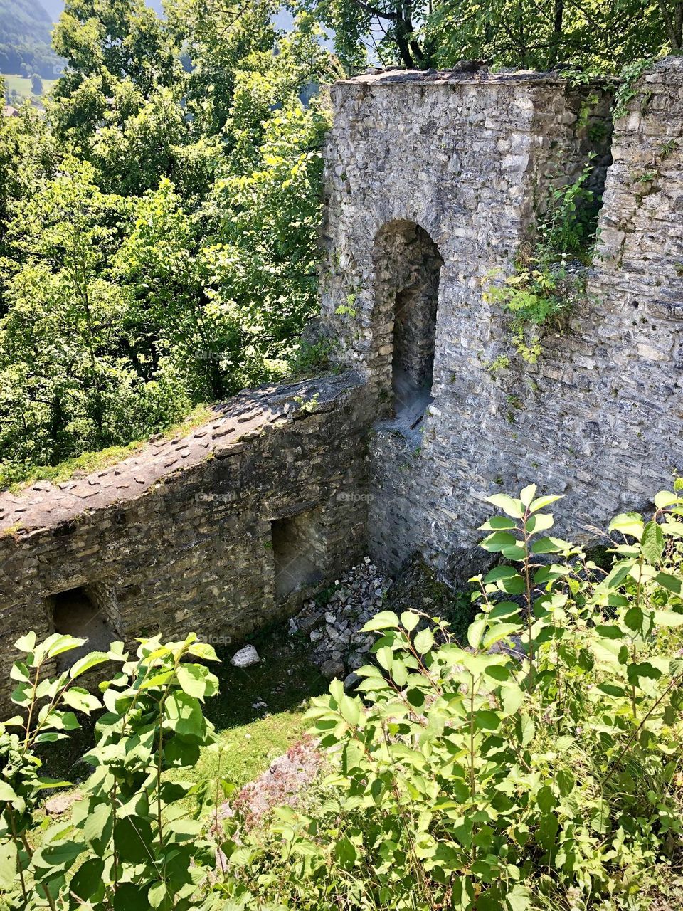 The ruins of a castle are nestled in the forest outside the town of Wilderswil, Switzerland 