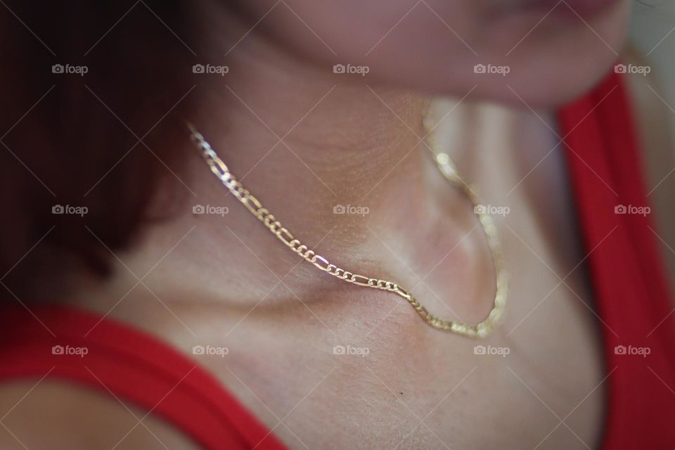 Golden chain on a young woman's neck