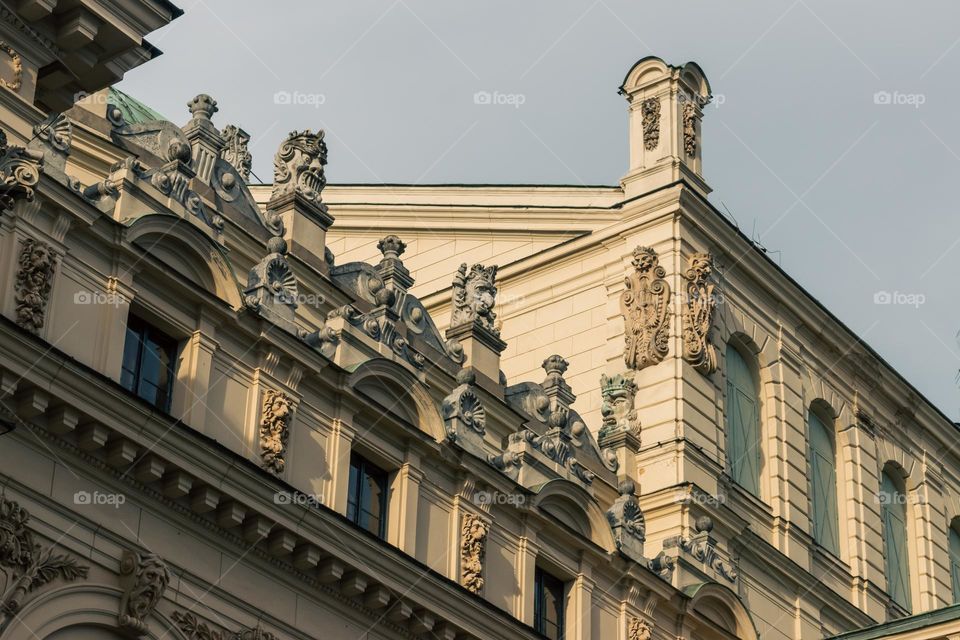 beautiful figures on top of the facade of the theater