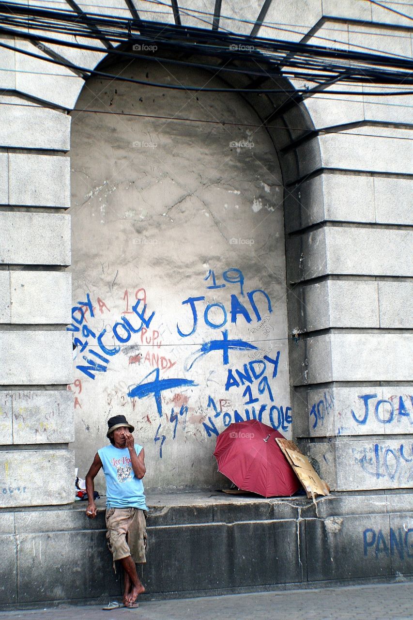 Man standing against arch wall