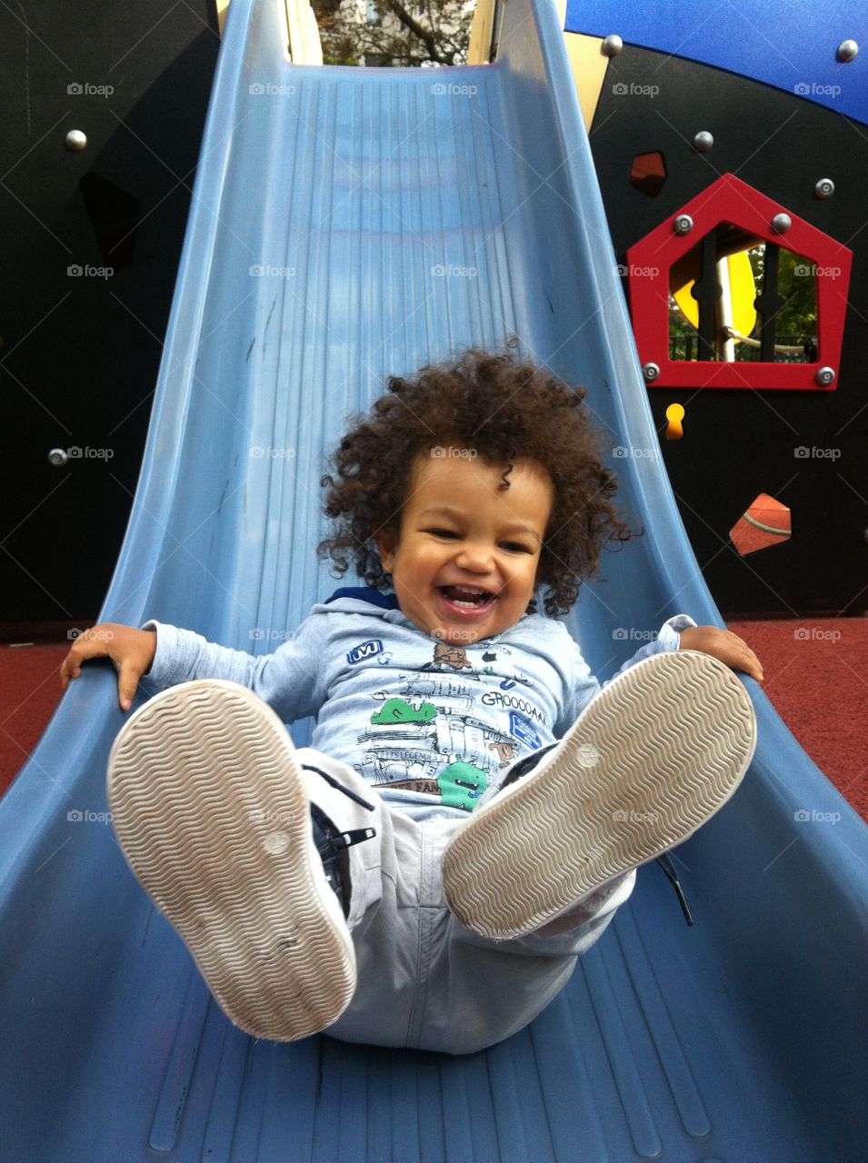 Small boy enjoying sliding