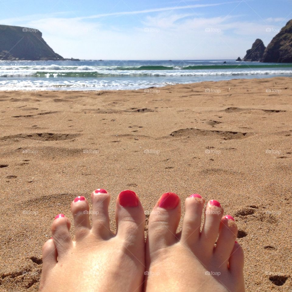 Feet at beach. View of feet and the beach