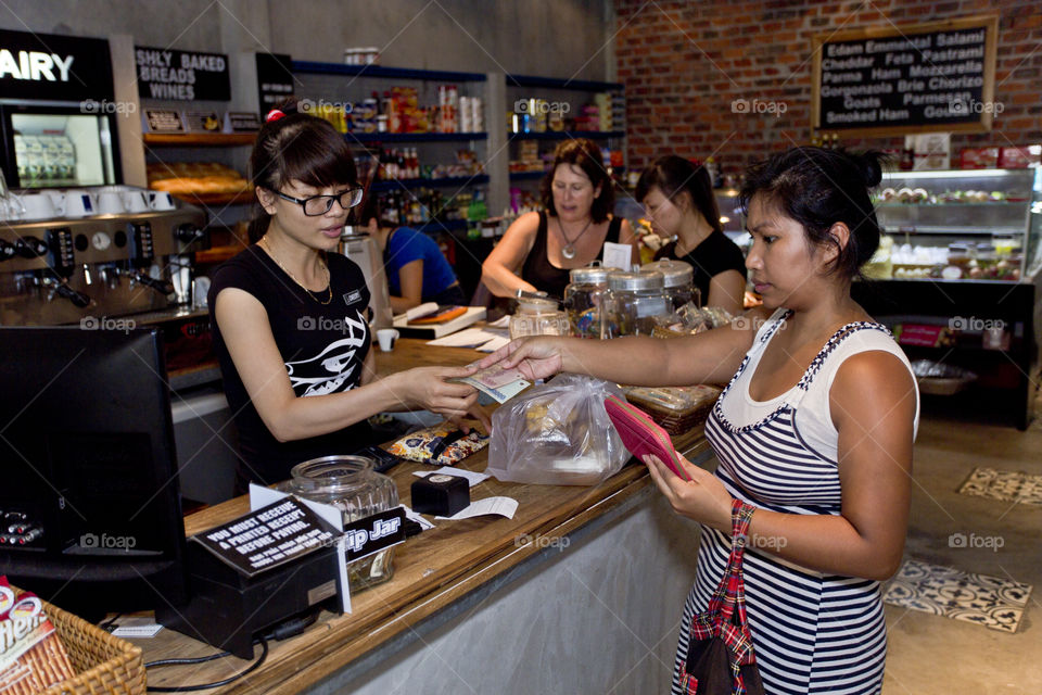 Small business. woman paying at cashier counter