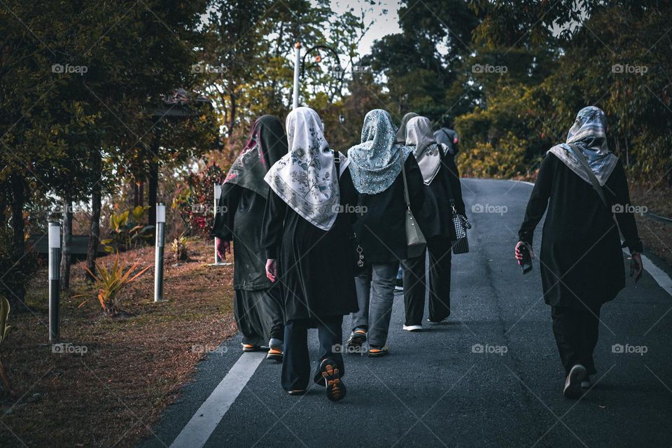Walking together up the hills display sisterhood and friendship on top of the mountains at sunrise.