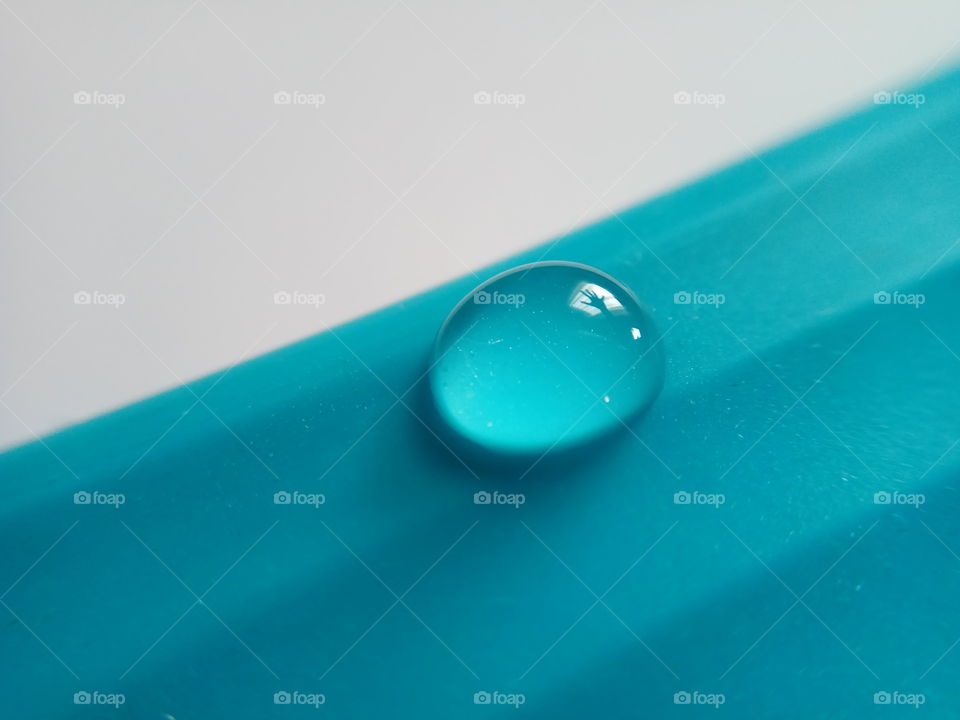 single water drop on blue