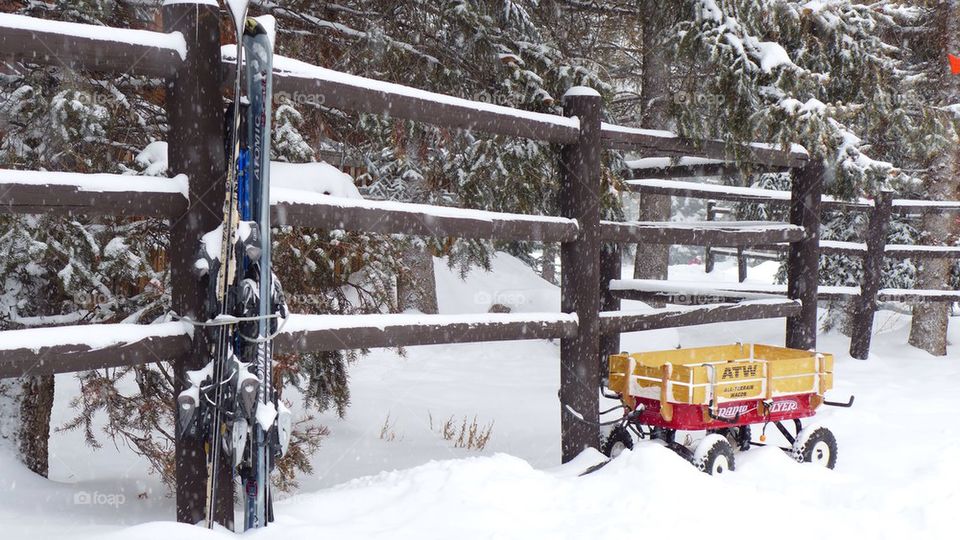 Little red wagon covered by snow