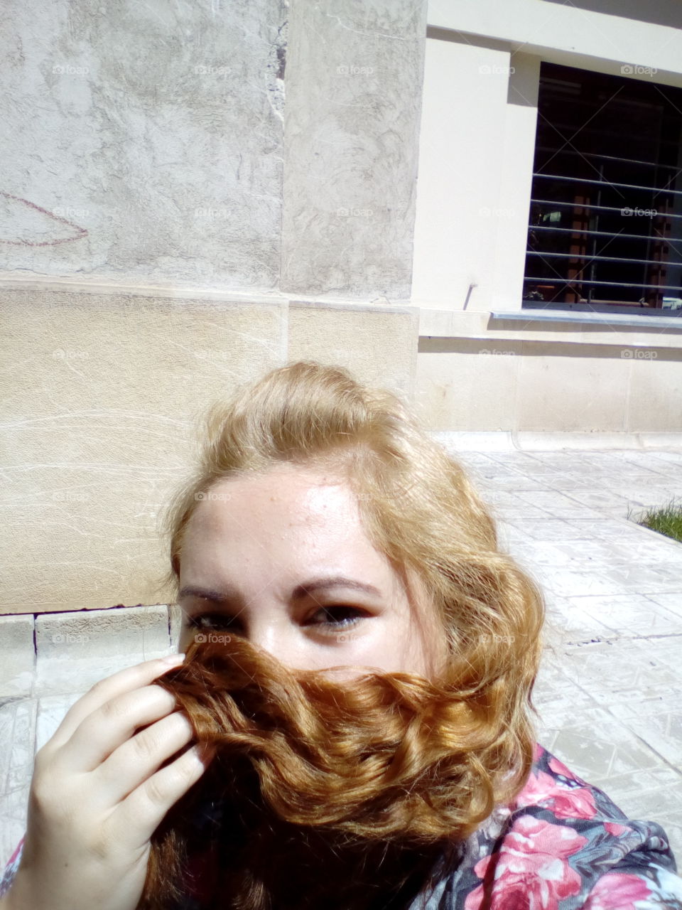 Young woman taking selfie with blonde hair