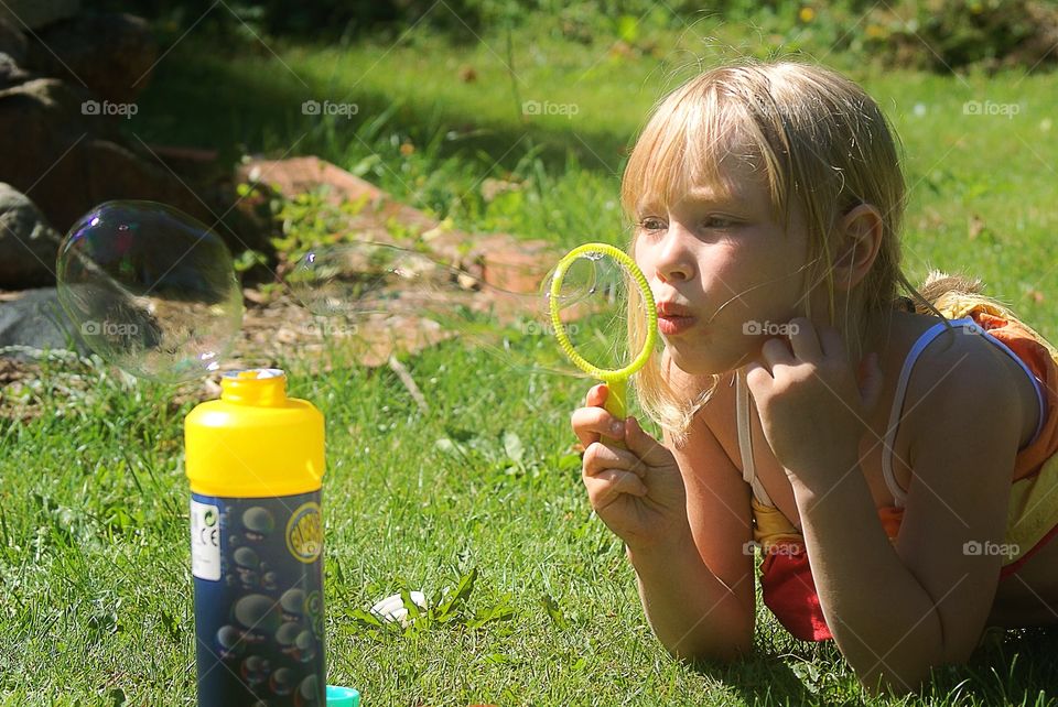 Girl blowing bubbles