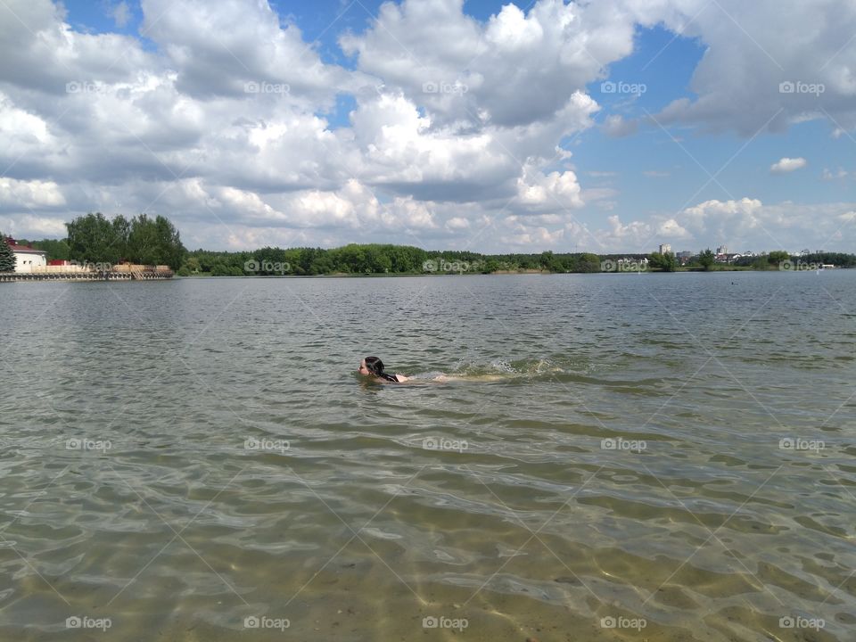 girl swimming in the water  lake summer landscape