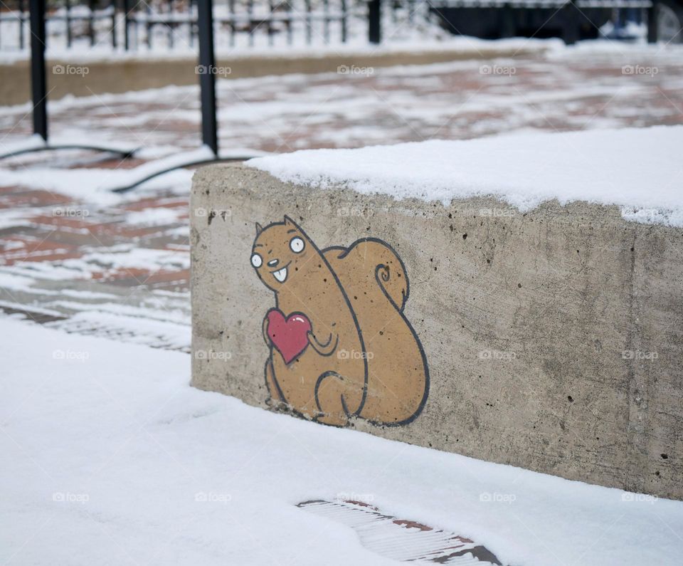 This cute little guy stands with his heart, looking at footprints in the snow. 