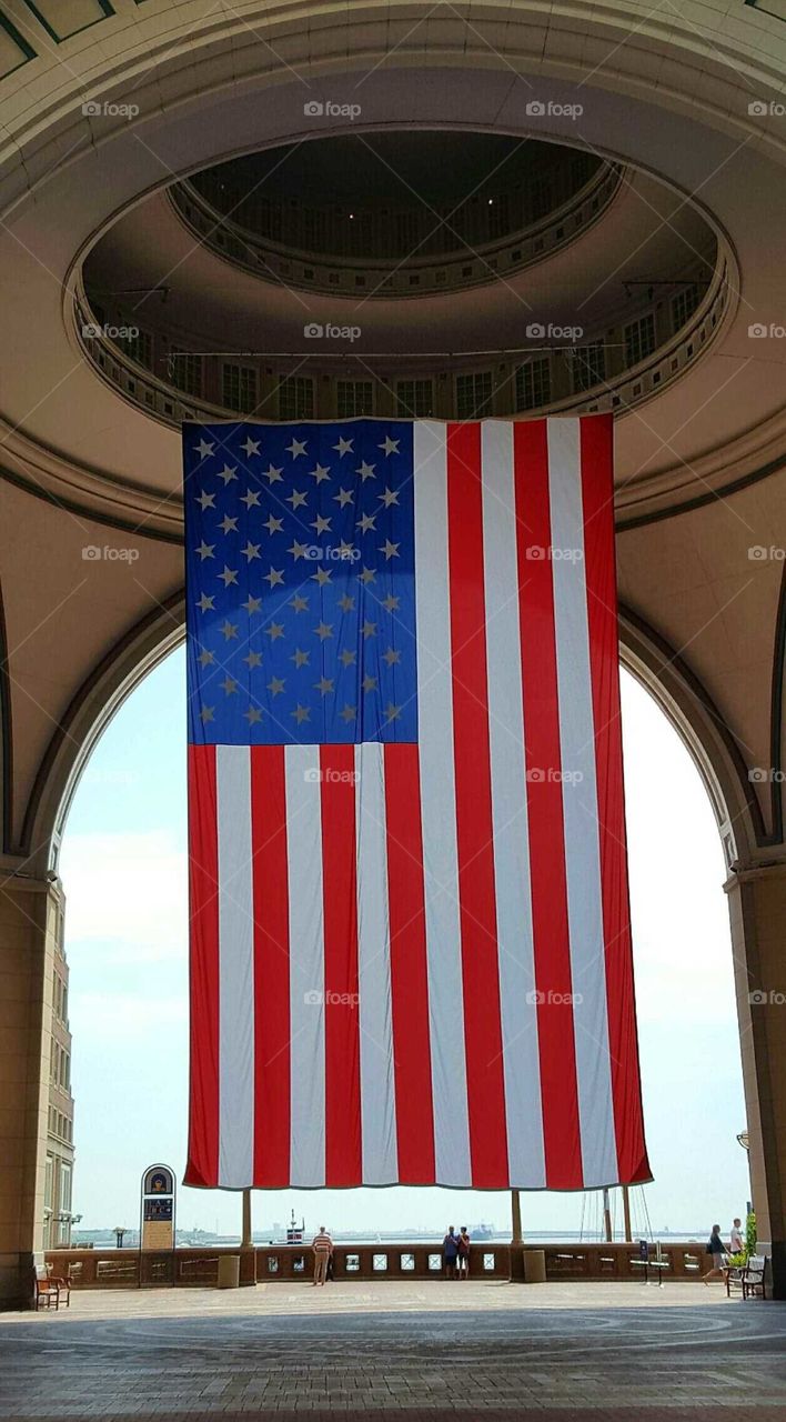 The US flag waves proudly along Boston Harbor.