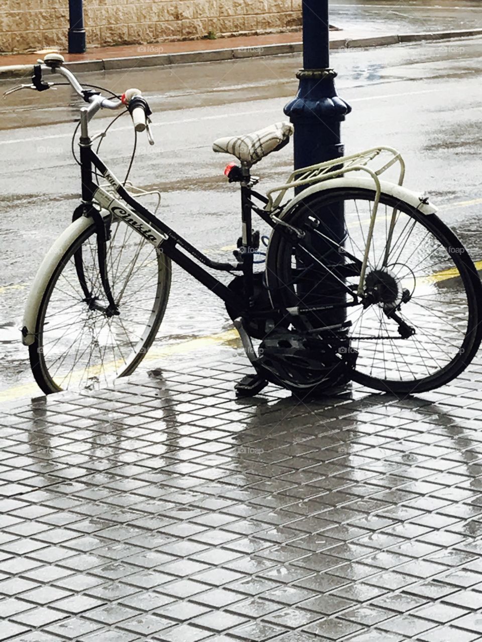 Bicycle-rides-rain-wet-post-wheel 