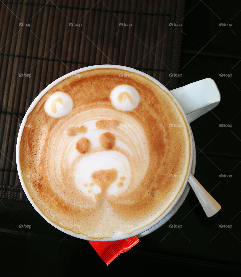 Latte art in a cup of coffee with milk 