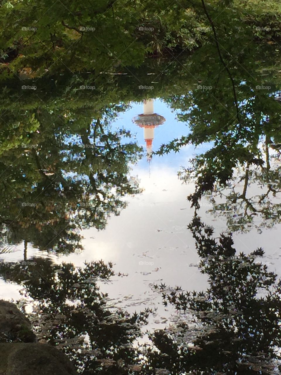 A reflection of Kyoto Tower in a millpond. Taken in Kyoto, Japan in autumn,2016. 