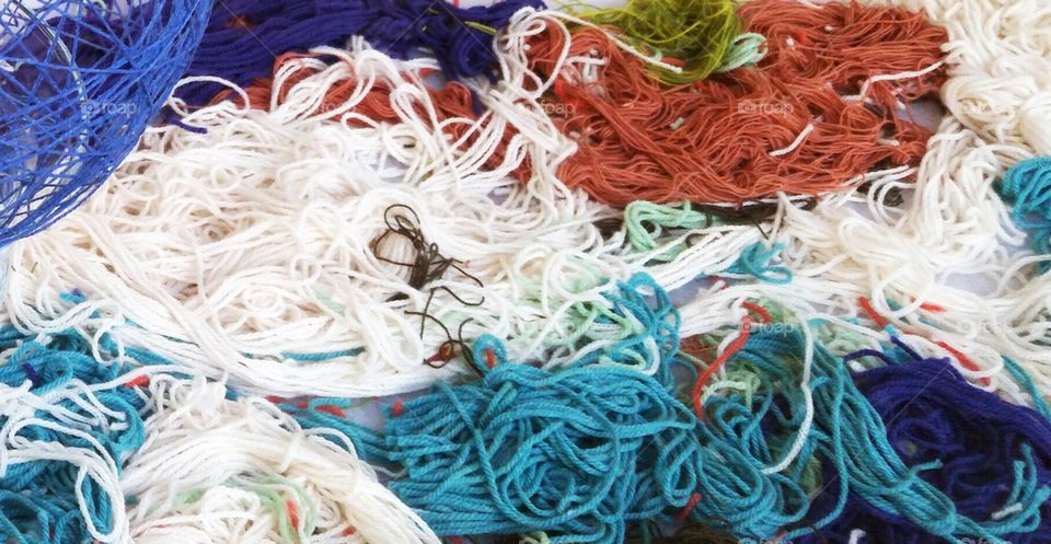 messy pile of tangled crafting yarn in a variety of colors