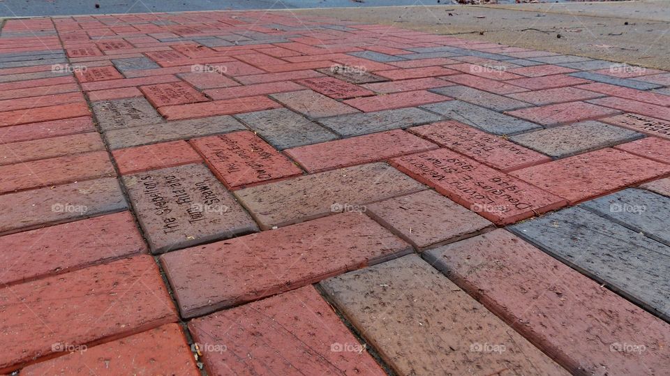 Writings in red brick on sidewalks 