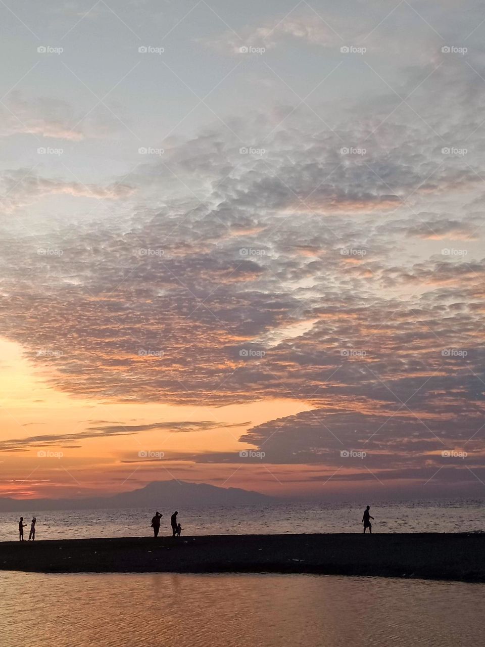 People enjoying the sunset at the beach