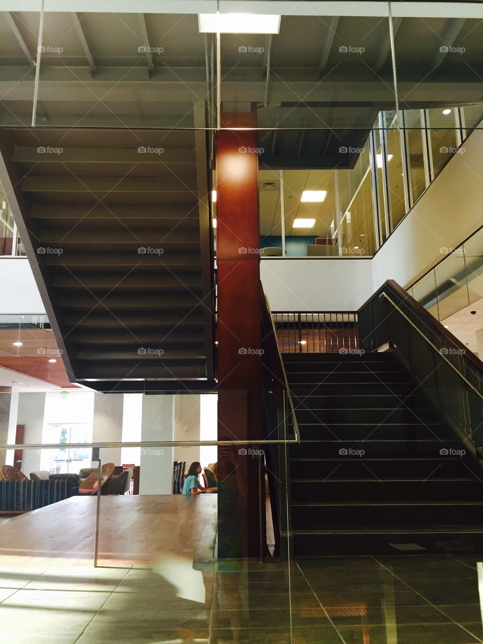 Modern office stairwell with worker station seating areas 