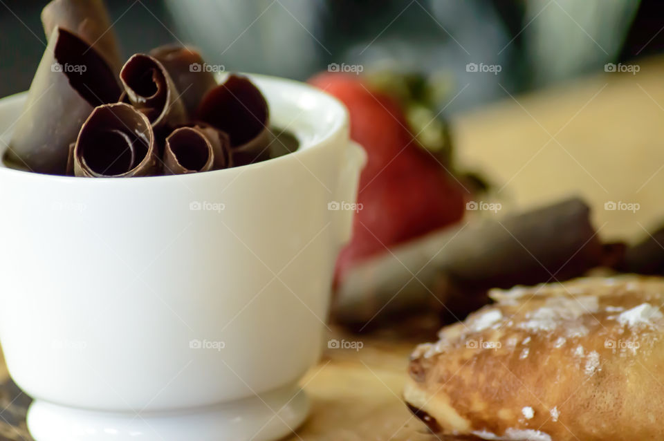 Bowl of chocolate kitchen cooking background with ingredients making chocolate strawberry crepes 