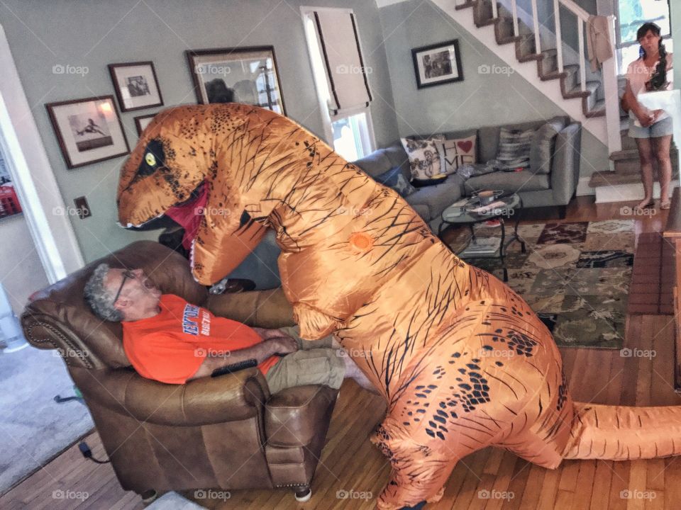 Senior man scared by fake dinosaur