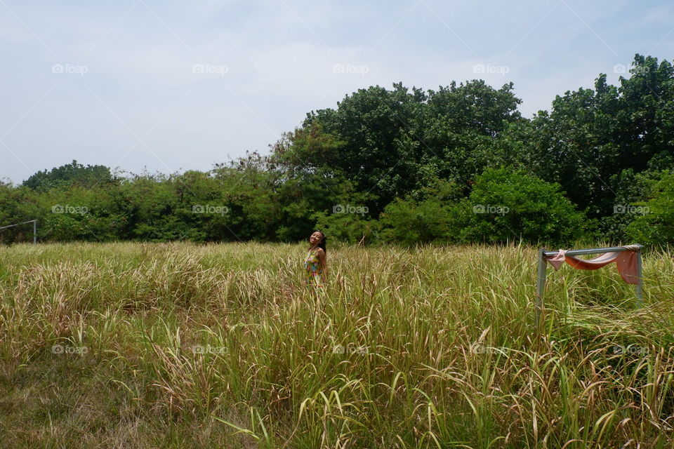 Woman in the middle of grass field