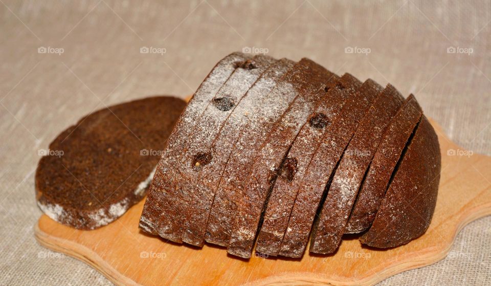 tasty healthy black bread on a wood board natural background