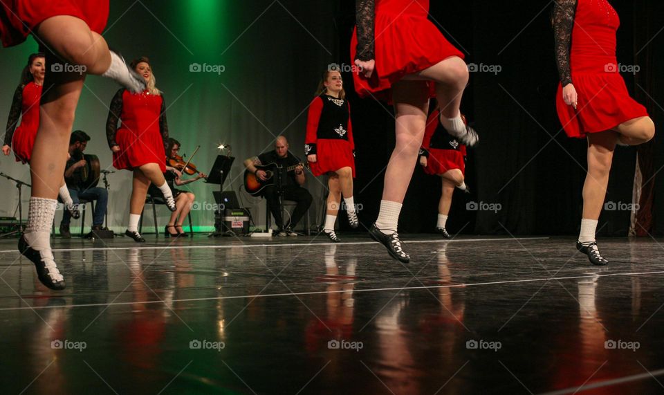 Irish dance show - dancers in foreground and musicians in background 