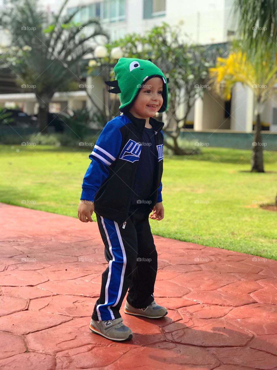 Kid playing soccer on the playground 
