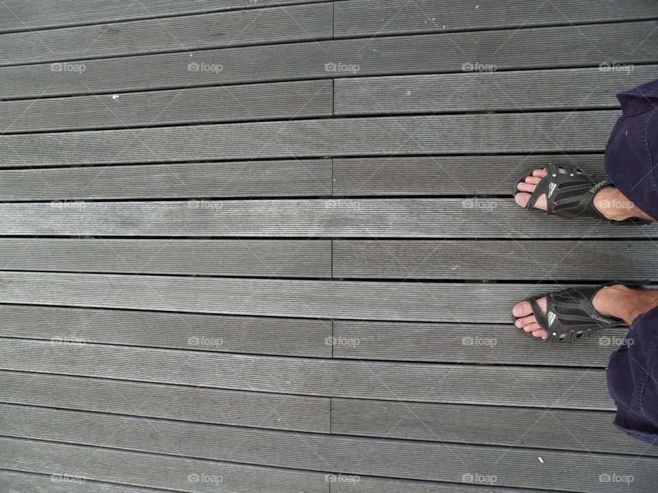 feet on the gray boards