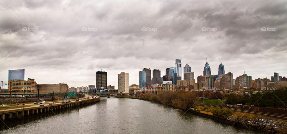 river skyline cloudy skyscrapers by teodorico