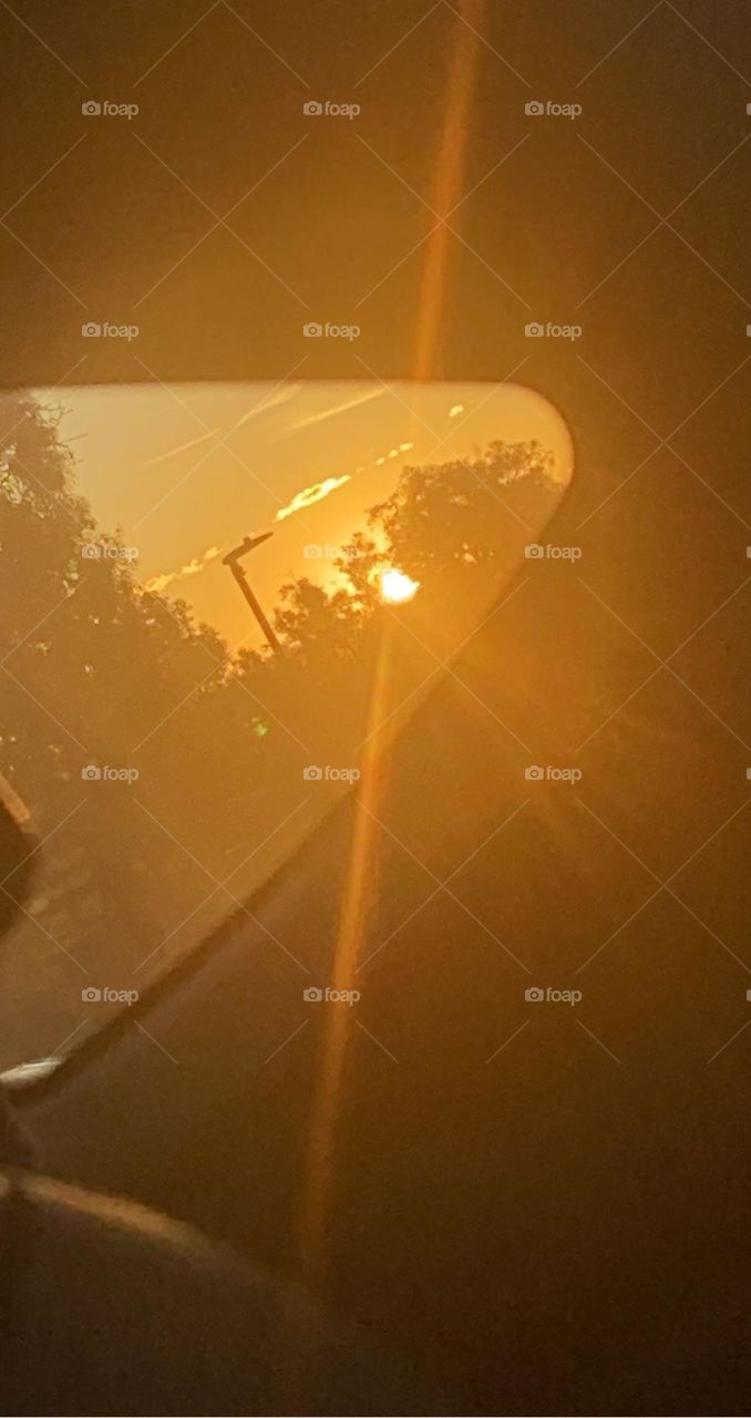 A sunset just peeking through the car window. It was so bright and such a vibrant orange colour! 