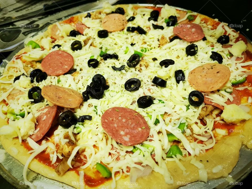 Pizza with olive and mozzarella cheese.