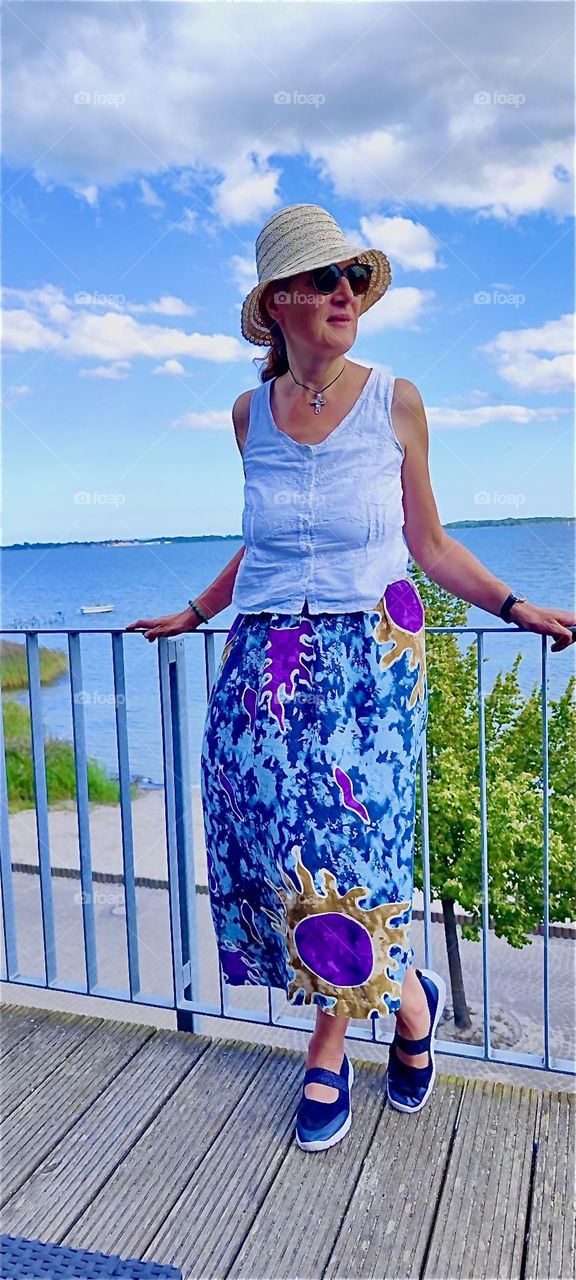 This beautiful lady enjoys a balmy afternoon breeze on the the island of “Rügen” by the “Strelasund”, a part of the “Baltic Sea” in the “Rügen - Western Pomerania” district of “Mecklenburg - Western Pomerania”, Germany. 2024. Hypnotic Productions