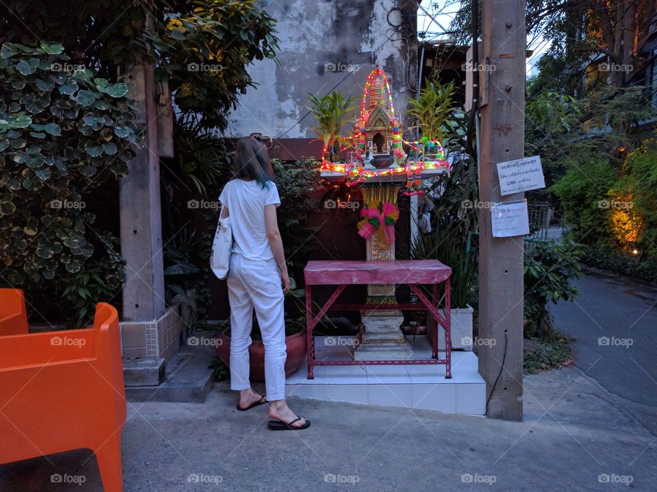 A girl in front of a shrine in bangkok