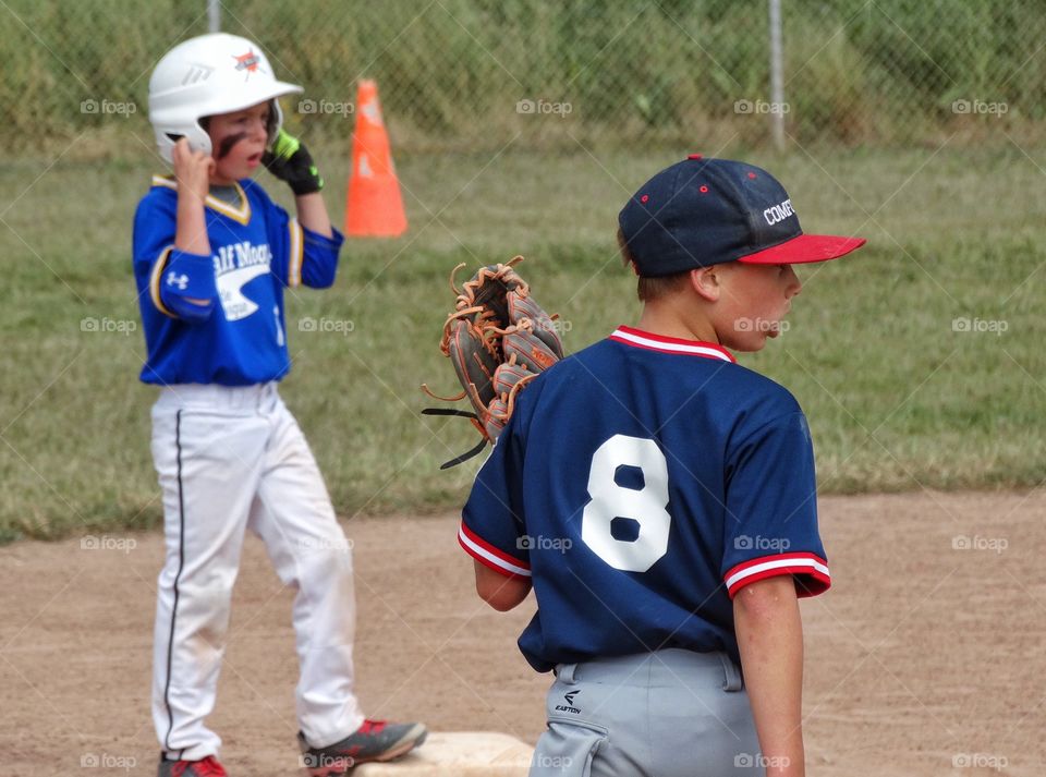Little League Baseball. Young Boys On Opposing Teams Playing American Little League Baseball
