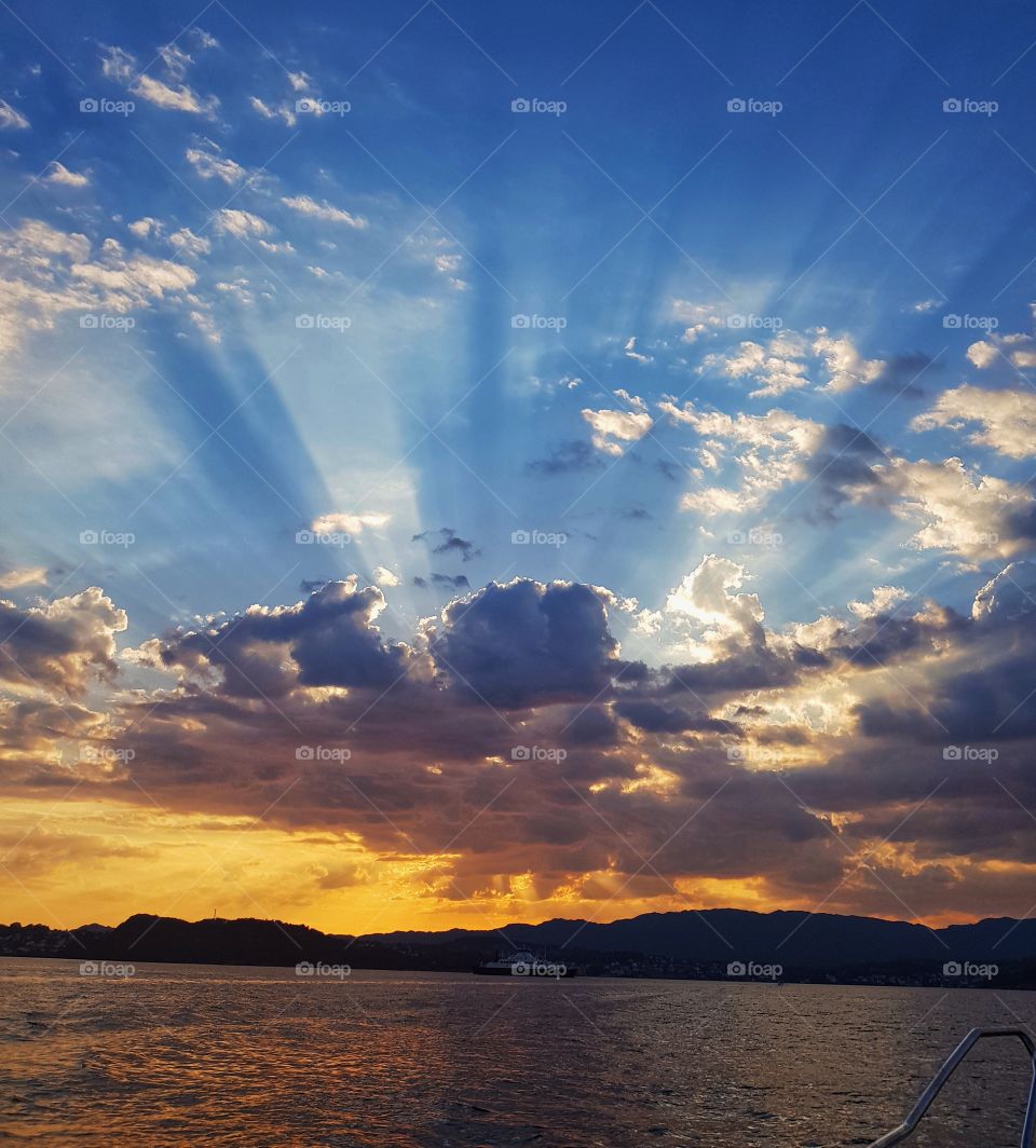 amazing cloud formation in sunset in norway from boat