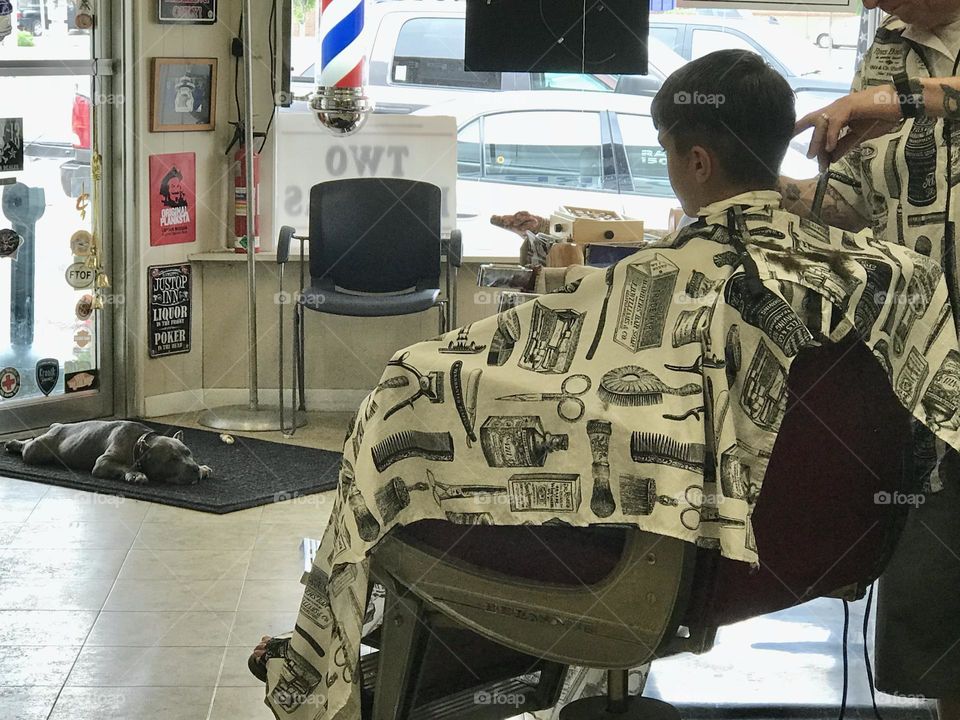 Boy getting hair cut in Barber shop 