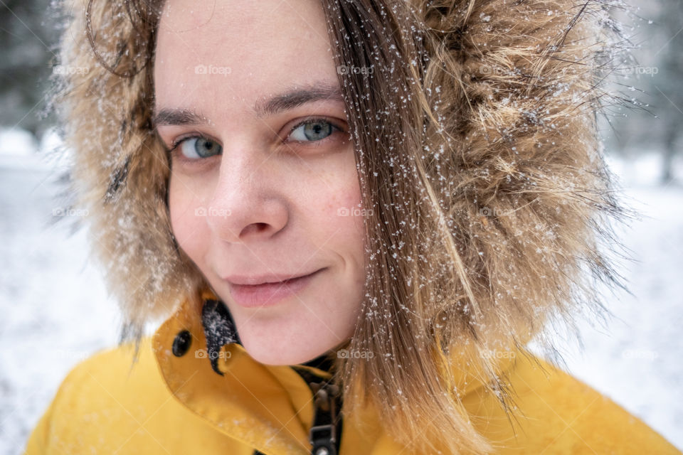 Young women Portrait with snow flakes on her hear
