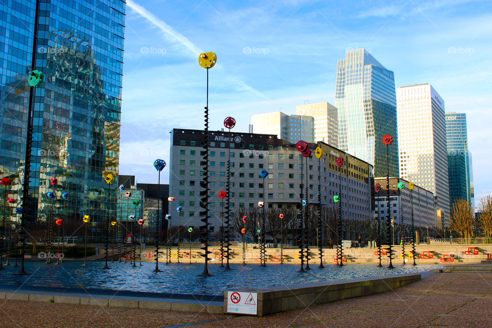 In the center of a square with modern buildings all around.The Defence,Paris.Europe