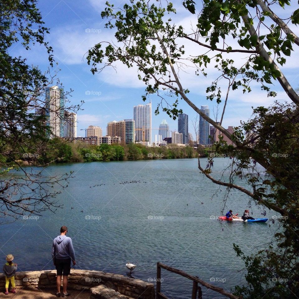 Rear view of person standing against river