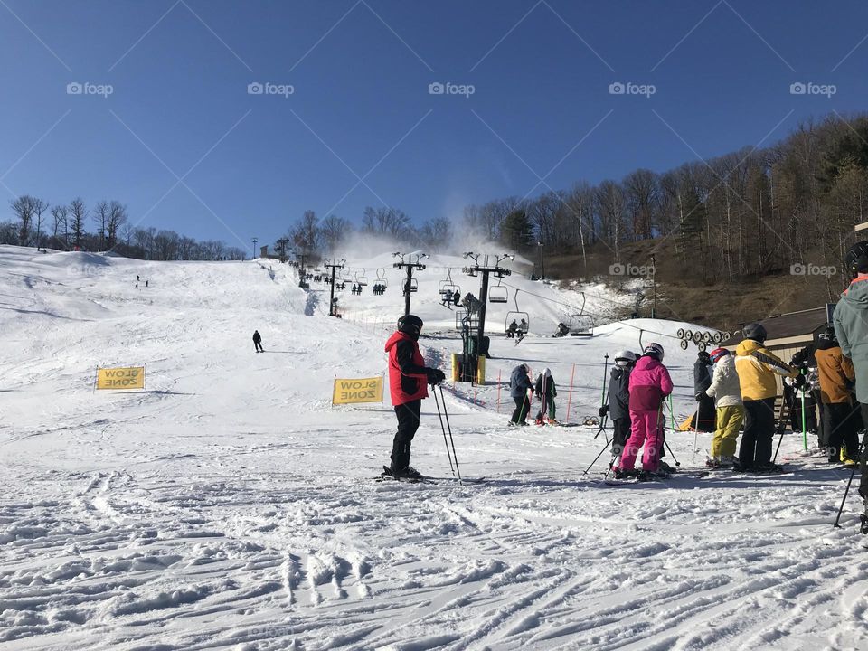 Snowboarders and skiers on slopes