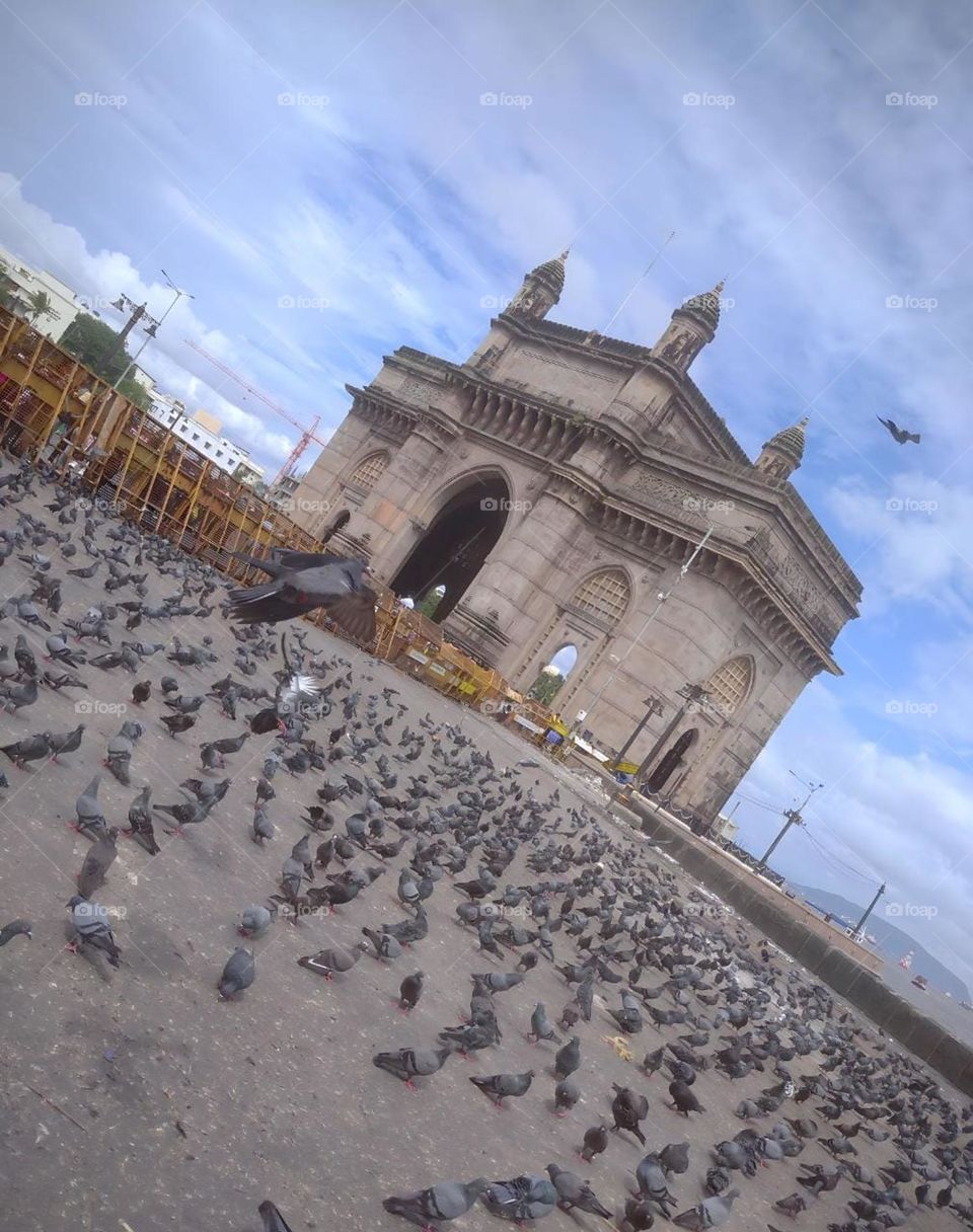 The Gateway of India is an arch monument built during the 20th century in Bombay, India. The monument was erected to commemorate the landing of King George V and Queen Mary at Apollo Bunder on their visit to India in 1911.