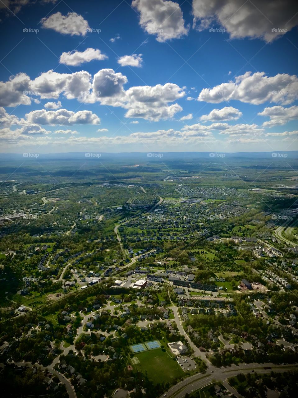 Lush green earth and blue skies with fluffy clouds 