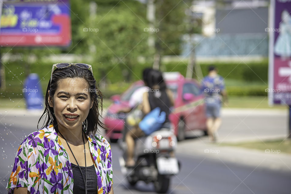 Asian woman play water in Songkran festival or Thai new year in Thailand.